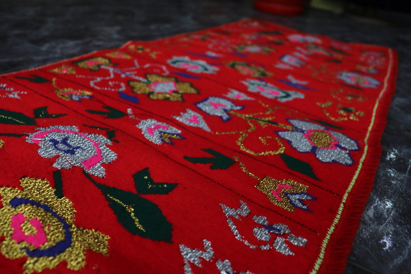 Red rug with white flowers