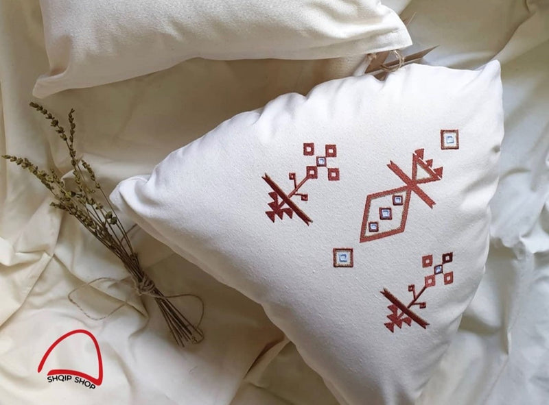 Embroidered pillow in traditional motifs